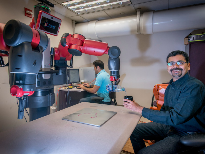 Ashwin Dani, assistant professor of electrical and computer engineering, is developing algorithms and software for robotic manipulation, to improve robotsÃ¢ interaction with humans. He is basically 'training robots to think.' He has a life size robot called Baxter in his lab. His work is said to be at the frontier of artificial intelligence. Sept. 7, 2017. (Sean Flynn/UConn Photo)